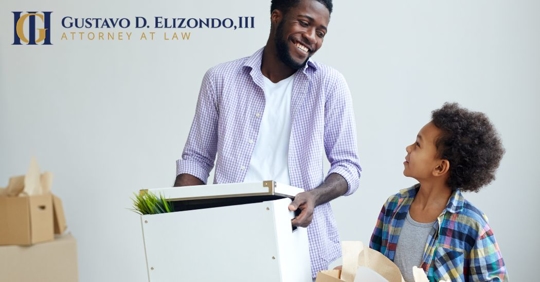 parent and child holding boxes for moving